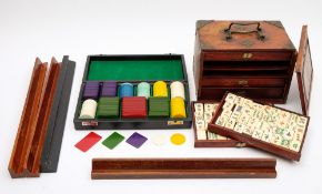 A cased set of celluloid gambling counters together with an early 20th century Ma Jong set and tile