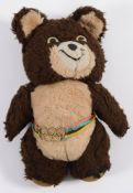 An Italian made 'Misha' Olympic mascot bear: wearing an Olympic ring multi-coloured belt, 38cm.
