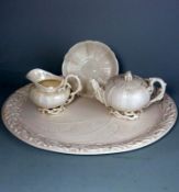 A Belleek part porcelain tea service in the Echinus pattern: comprising an oval tray,