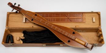 A mahogany dulcimer by F C Bond:, of traditional form with heart shaped sound holes,