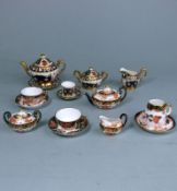 A Royal Crown Derby miniature porcelain tea service and one other: comprising a teapot and cover,