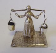 A Dutch silver milkmaid figure:holding a yoke with two suspended pails, bears import marks, 3.5cm.