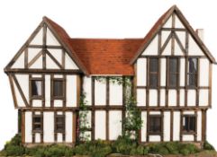 A bespoke dolls house by Connor and Cameron Dollhouses in the Tudor-style: with exposed beams,