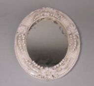 A Belleek porcelain oval Lily of the Valley mirror: first black mark, 27 cm high.