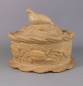 A cane ware pie dish and cover: of oval form the dish rim and base moulded with ears of wheat and