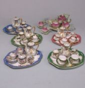 An Austrian bisque porcelain miniature cabaret set and five miniature hard paste coffee services: