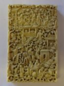 A Cantonese carved ivory card case:, decorated with figures in a pagoda landscape, 11 x 7cm.