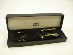 A Mont Blanc fountain pen and ball point pen set:, in black with gilt mounts.