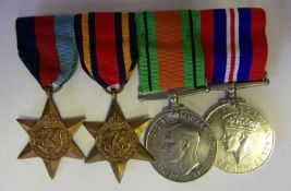 A group of four World War II medals: includes 1939-45 Star, Burma Star, Defence and War Medals.