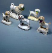 Five Staffordshire porcelain poodle figures: each modelled standing with a basket of flowers in