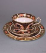 A Royal Crown Derby porcelain cup, saucer and plate: each decorated in the Imari pattern,