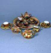 A Coalport porcelain miniature fruit painted tea set and a similar Caverswall example: the former