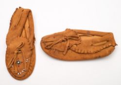 A pair of North American Native child's leather moccasins with traditional beadwork decoration:.