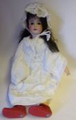 A German bisque head doll: impressed Gbr 165 K 14 Germany, with brown mohair wig,