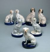 Three pairs of Staffordshire and later Dalmatians and one other: each in seated posture on oval