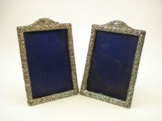 A pair of George V silver scroll decorated picture frames, Birmingham 1927:, 18.5cm high.