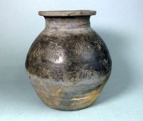 A Chinese neolithic-style grey pottery jar: incised with characters above concentric bands,