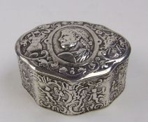 A continental silver box and cover bears import marks for London, 1894: of cartouche shaped outline,