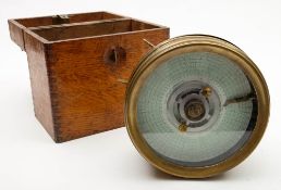 A brass plated circular cased pigeon racing clock:, numbered 26742, in an oak case, 17cm diameter.