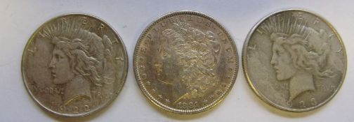 Three American one dollar coins: 1881, 1922 and 1923.