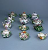 A group of toy florally encrusted porcelain tea ware: comprising nine various tea pots and kettles,