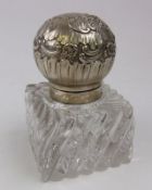 A continental silver mounted clear glass inkwell: monogrammed, of square outline,