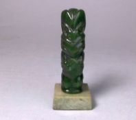 A New Zealand Maori carved nephrite Hei Tiki figure: with three-fingered hands, late 20th century,