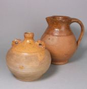 A Verwood pottery 'owl' costrel and jug: the former of typical globular form with raised ribbed lug