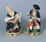 A pair of Derby figures: one of a seated boy with a dog at his feet,