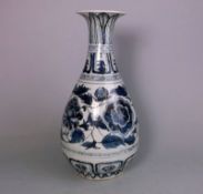 A Chinese blue and white bottle vase: in Yuan Dynasty style, painted with peony,
