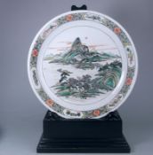 A large Chinese porcelain famille verte dish: of circular shallow form enamelled with an extensive