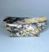 A Chinese jade pillow: in Han Dynasty style, each side carved with a simple mask,