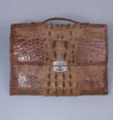 A Ladies crocodile skin slip case: with carrying handle and leather lined interior the metal clasp