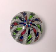 A John Deacons glass paperweight: set with a central cluster of canes with radiating colourful