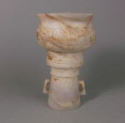 A Chinese hardstone pedestal vessel: the baluster bowl carved with a band of comma motifs,