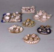 Four miniature Limoges porcelain cabaret sets and three others: the former on oval trays and