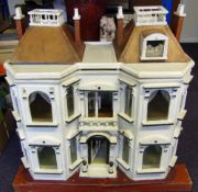 An Edwardian period doll's house: the double hinged front enclosing two ground floor rooms and hall,