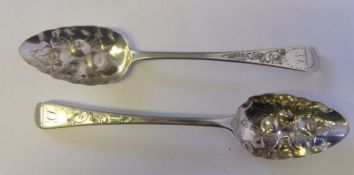 Two George III silver later decorated berry spoons, maker Robert Rutland, 1810 and 1814: initialled,