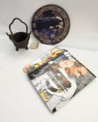 A collection of metalware jugs, carved wooden objects,