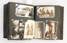 A postcard album, black leather book containing seaside views,