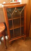 Oak glazed bookcase with glazed panel door enclosing adjustable shelves,
