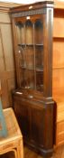 Reproduction mahogany corner cupboard, the astragal glazed door enclosing shelves,