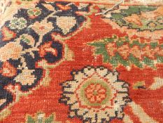 Eastern wool rug with asymmetric design, on red field,