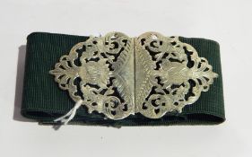 A white metal belt buckle of open foliate fretwork design (marks rubbed)