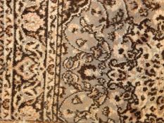 Large wool rug on blue field with white borders and black fences, floral design,