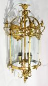 Decorative gilt metal four-light hanging lantern of circular form, having four glass panels,