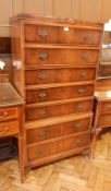 A contemporary walnut veneer chest on chest of seven long drawers raised on short cabriole legs,