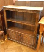 A reproduction oak bookcase with moulded edge top,