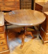A Georgian style mahogany circular top supper table on turned column support with splayed tripod