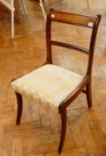 A set of six 19th century dining chairs with upholstered gold and white floral cushions